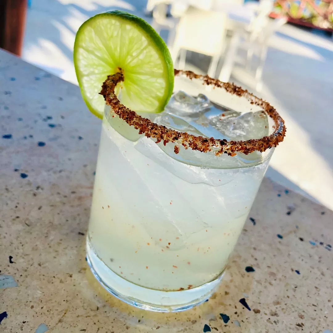 One margarita with a lime and tajin garnish on the counter at La Sirena in Puerto Morelos.