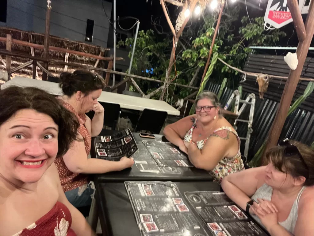 Four female friends enjoying rooftop dining at La Choza del Puerto.