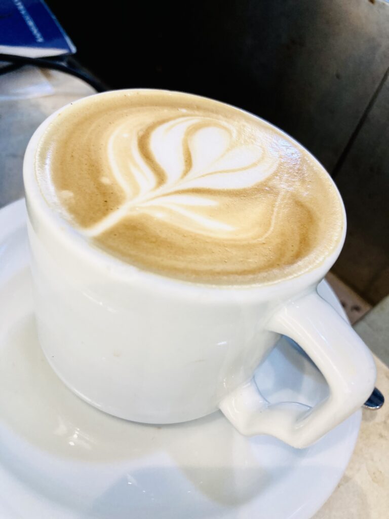 Coffee cup with a heart design in the foam on top of the latte beverage inside. A taste of France in Mexico.