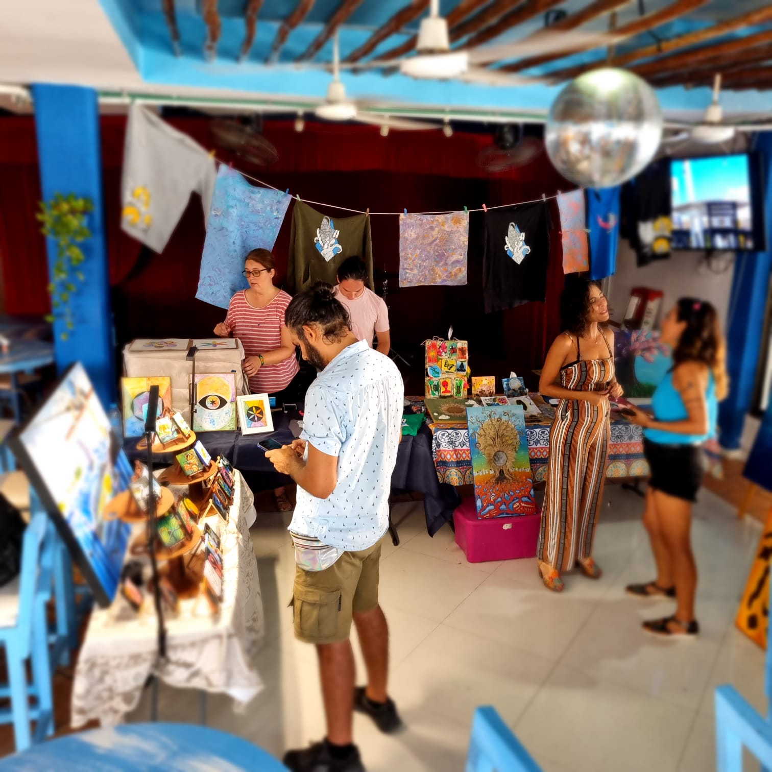 People in an art gallery fundraiser at La Sirena, Puerto Morelos