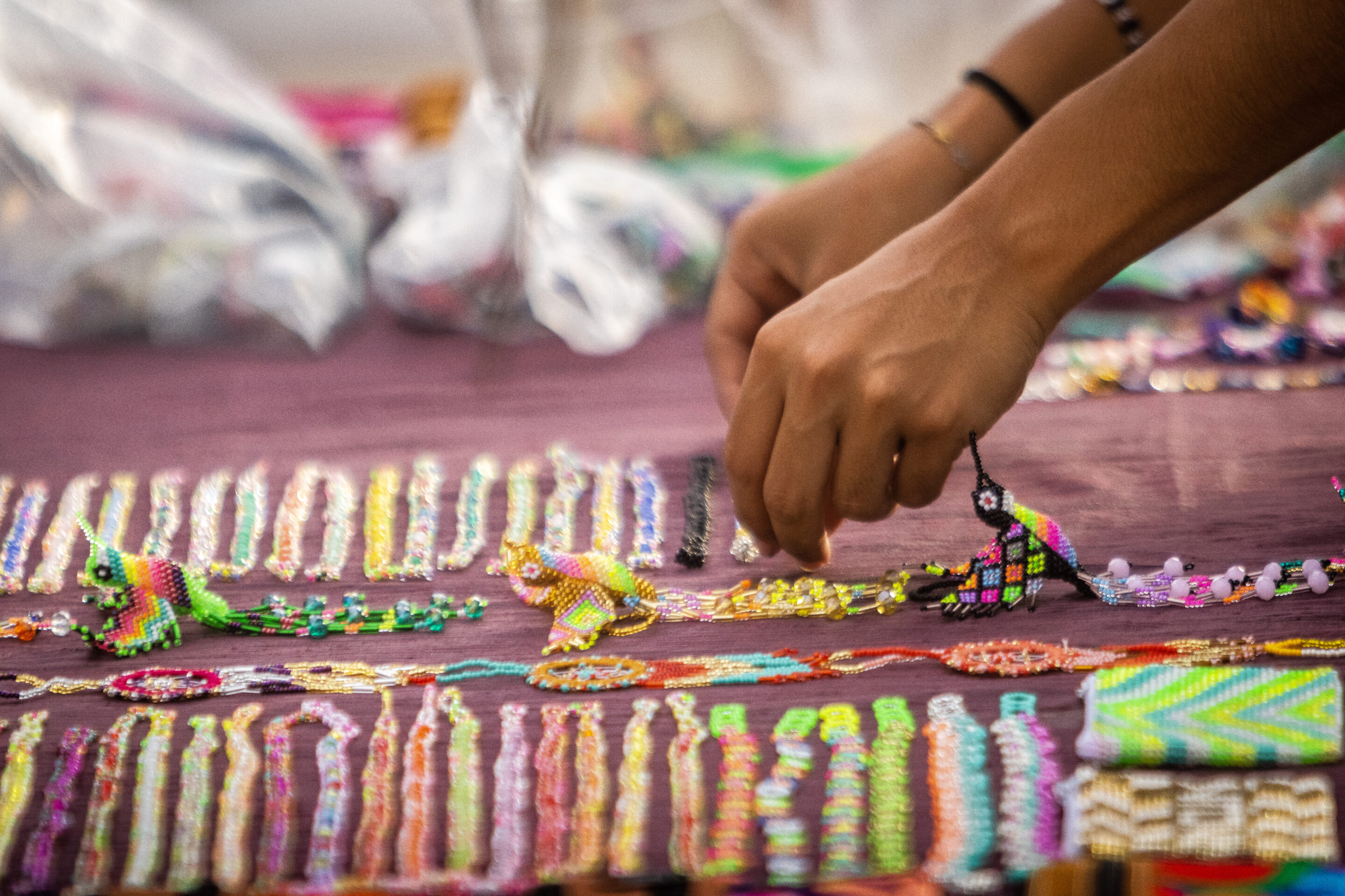 Seed beed bracelets and hummingbirds being displayed at the artisan market in Puerto Morelos.