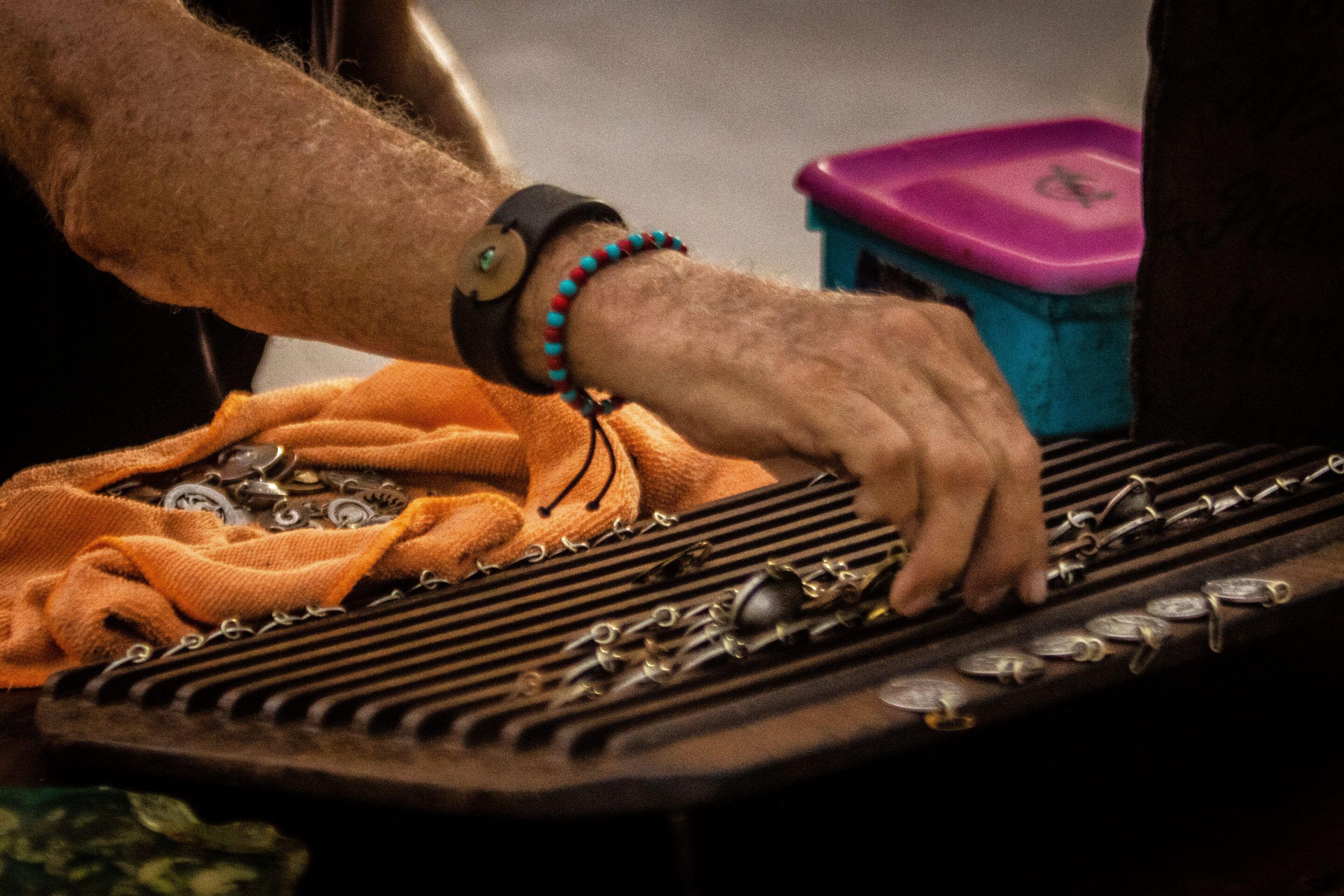 A view of a hand placing jewelry on a display.