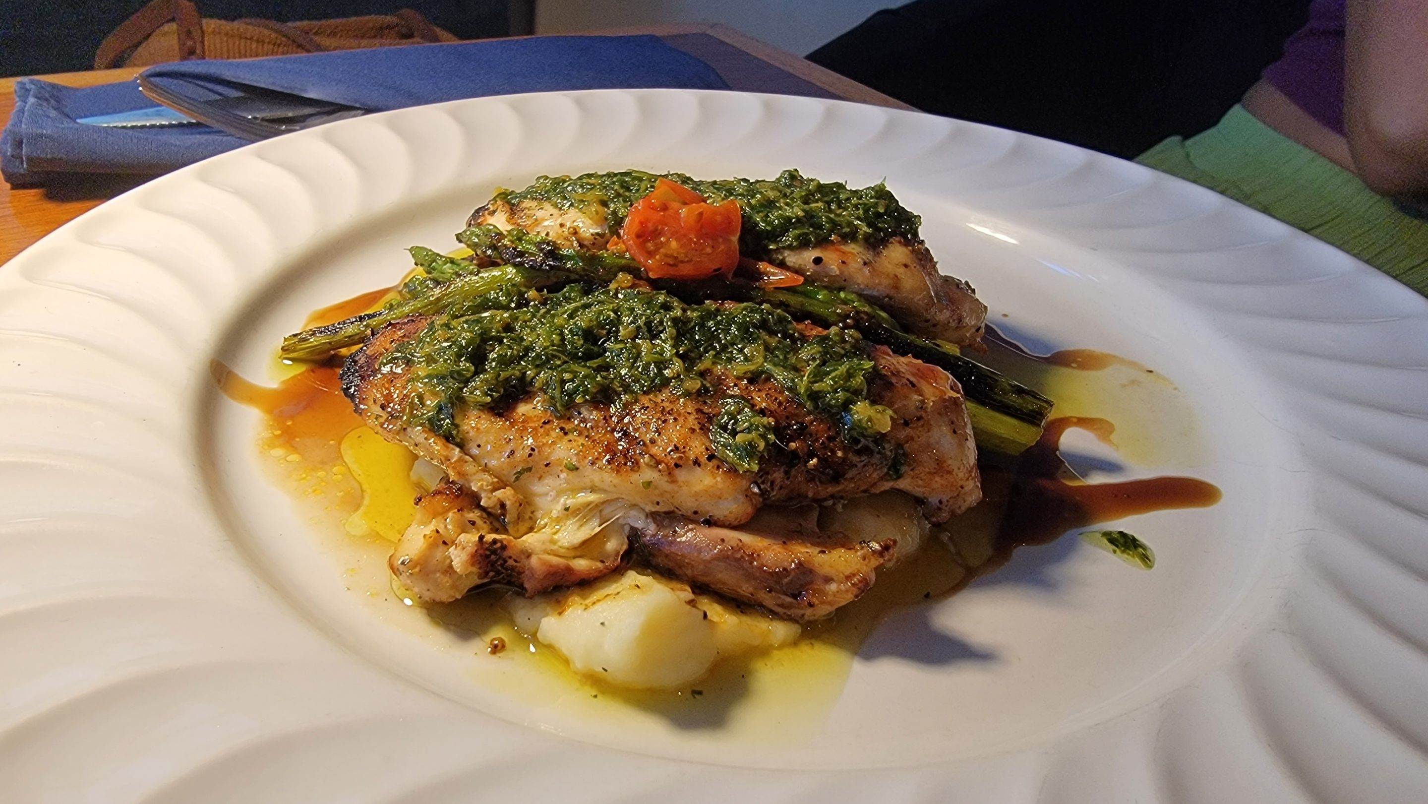 Grilled chicken with a cilantro pesto sauce on a bed of creamy mashed potatoes at John Gray's Kitchen in Puerto Morelos.