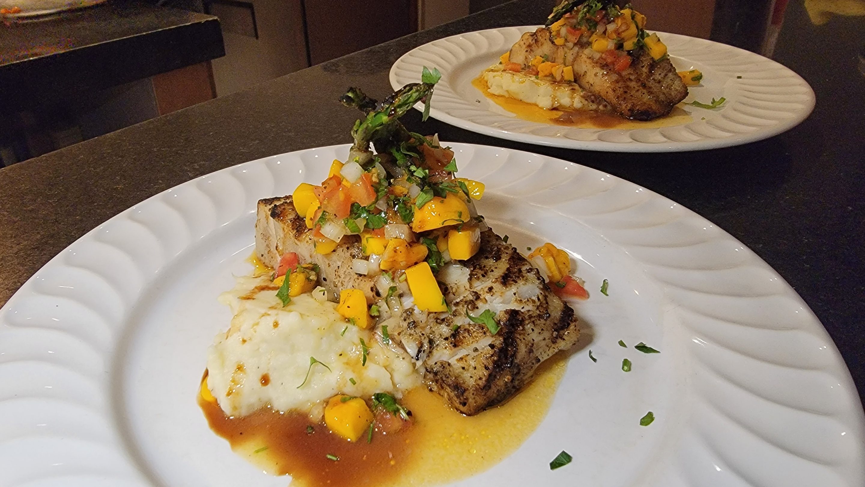 John Grays Kitchen in Puerto Morelos serves grilled fish with asparagus and mashed potatoes in mango salsa.