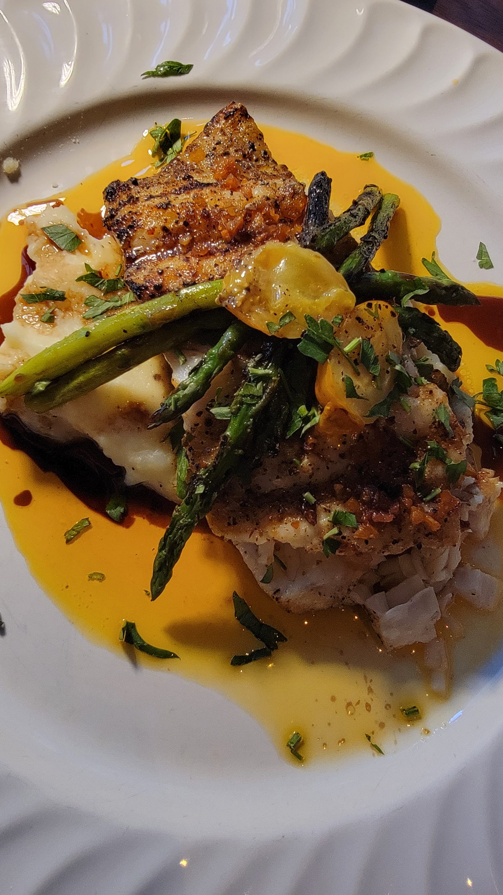 John Gray's Kitchen in Puerto Morelos serves grilled fish with asparagus and mashed potatoes in garlic butter sauce.