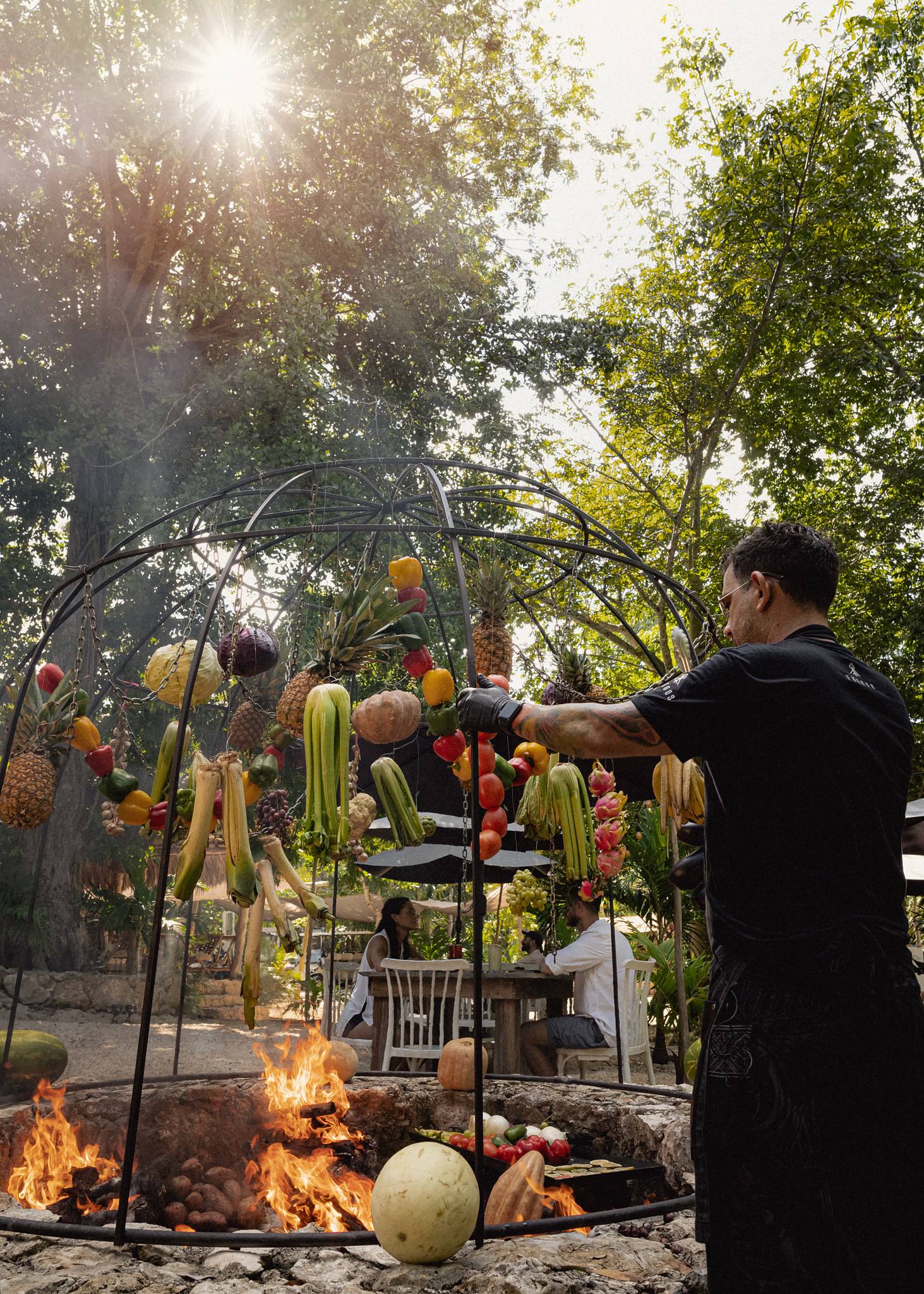 Chef Marcos Walfisch roasts organic vegetables over woodfire at Fuegos de Xul-Ha on the Ruta de Cenotes.
