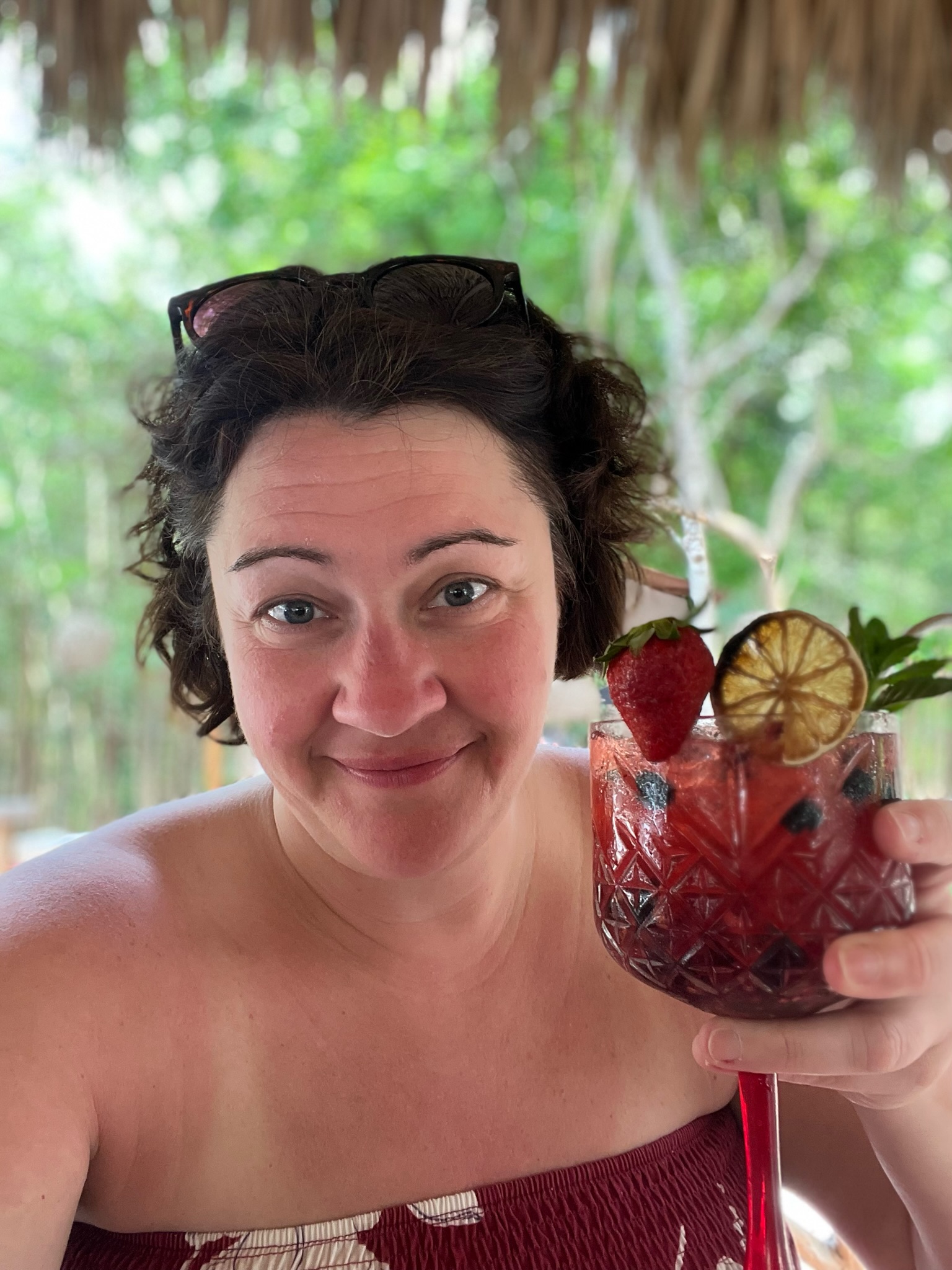 A guest enjoying fabulous cocktails made with organic fresh fruit like oranges, strawberries, and blueberries at Fuegos de Xul-Ha in the Mayan jungle on the Ruta de Cenotes outside Puerto Morelos.